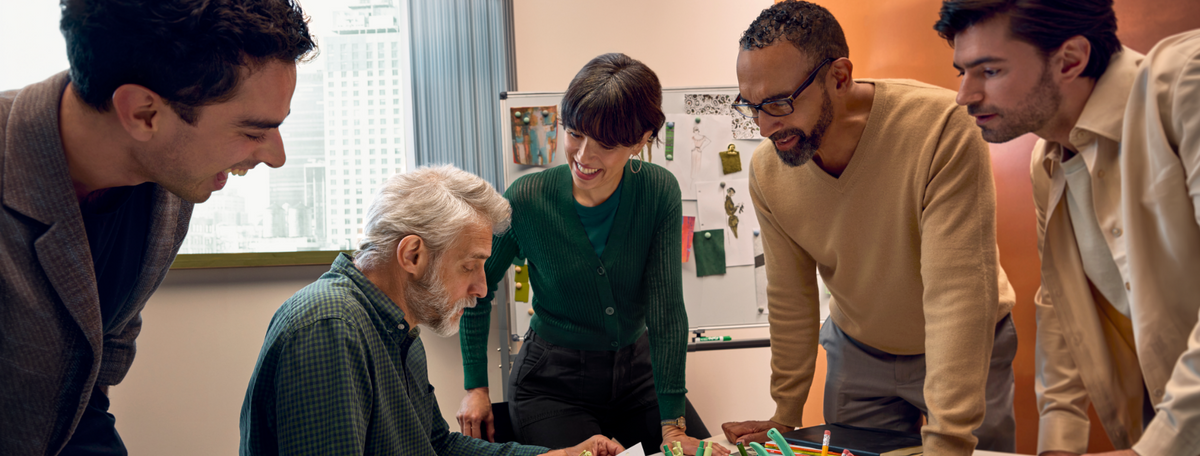 Group of people talking in a busy office