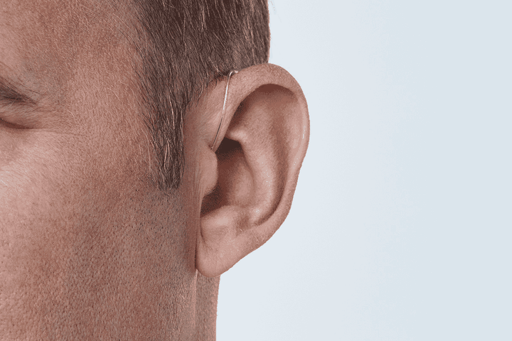 Oticon miniRITE R hearing aid – close-up on a man's ear at a 45 degree angle